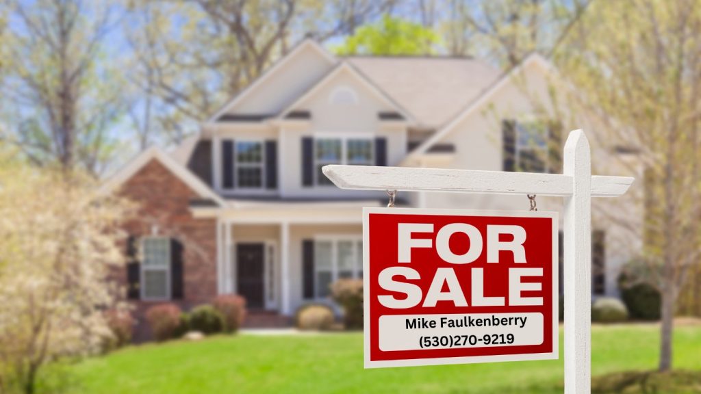 Red and white For Sale sign with Mike Faulkenberry's contact information, placed in front of a beautiful suburban home in Nevada County