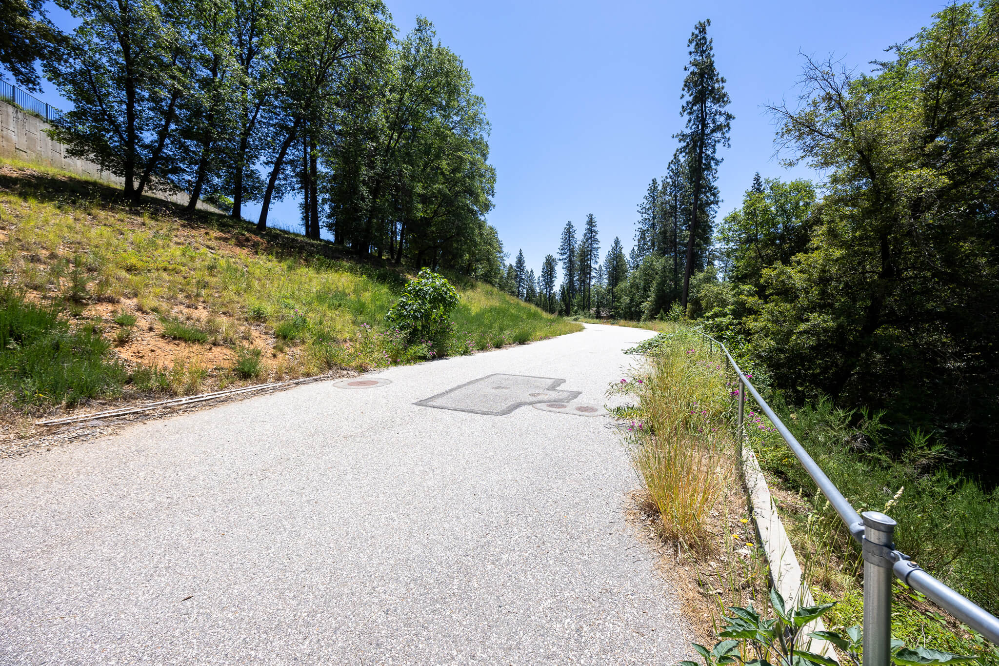 Paved street with curbs and manholes at River Otter Way subdivision